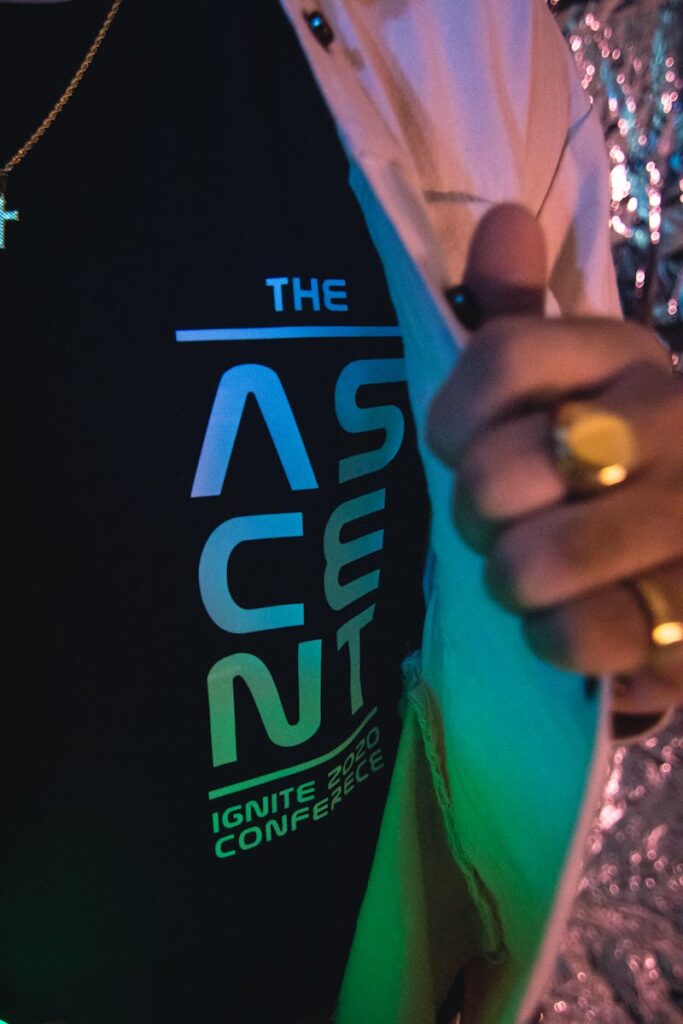 A detailed shot of a black T-shirt featuring the Ascent Conference logo in a stylish composition.