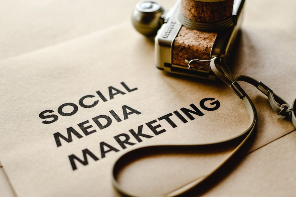 Close-up of a camera placed on brown paper with 'Social Media Marketing' text, emphasizing digital marketing themes.